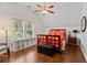 Bedroom showcasing hardwood floors, a cozy reading nook, and a bed dressed with colorful linens at 1589 Delano Dr, Decatur, GA 30032