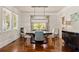 Bright dining room with large windows, hardwood floors, modern lighting, and classic decor at 1589 Delano Dr, Decatur, GA 30032