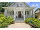 Charming home featuring a welcoming front porch with decorative railings and a landscaped front yard at 1589 Delano Dr, Decatur, GA 30032