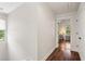 Bright hallway featuring hardwood floors, white walls, and natural light streaming in from a nearby window at 1589 Delano Dr, Decatur, GA 30032