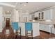Kitchen with granite countertops, stainless steel appliances and breakfast bar with blue cushioned chairs at 1589 Delano Dr, Decatur, GA 30032