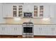 Well-lit kitchen features white cabinets, stainless steel appliances, and granite countertops at 1589 Delano Dr, Decatur, GA 30032