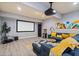 Open basement living room with projector, movie screen, and comfortable sectional sofa at 1589 Delano Dr, Decatur, GA 30032