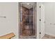 Corner shower with glass door and decorative stone tile at 1589 Delano Dr, Decatur, GA 30032