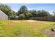 Spacious backyard enclosed with a wood fence and lush green grass at 163 Silver Fox Trail Trl, Dallas, GA 30157