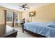 Comfortable bedroom featuring a ceiling fan, natural light, and a dedicated desk space at 163 Silver Fox Trail Trl, Dallas, GA 30157