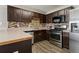 Modern kitchen features stainless steel appliances, dark wood cabinetry, and a stylish backsplash at 163 Silver Fox Trail Trl, Dallas, GA 30157