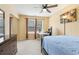 Cozy bedroom featuring a ceiling fan, natural light, a dresser, and a closet at 163 Silver Fox Trl, Dallas, GA 30157