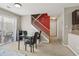 Open dining area with view of staircase and access to a bright kitchen area and outdoor patio at 163 Silver Fox Trl, Dallas, GA 30157