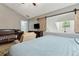 Bedroom featuring a slider to the landing, television, crib and view of bathroom at 163 Silver Fox Trl, Dallas, GA 30157