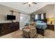 Vaulted ceiling bedroom featuring a slider, mounted television, dresser, and chair for comfort at 163 Silver Fox Trl, Dallas, GA 30157