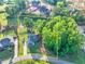 Aerial view of a property showcasing the home, landscaping, spacious yard, and surrounding tree line at 2980 Beards Rd, Buford, GA 30518
