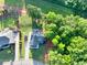 Expansive aerial view of a single-Gathering home with a long driveway, lush green lawn, and mature trees at 2980 Beards Rd, Buford, GA 30518
