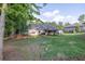 Expansive backyard with lush green lawn, mature trees, and a covered patio, perfect for outdoor enjoyment at 2980 Beards Rd, Buford, GA 30518