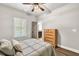 Bedroom with hardwood floors, a window with blinds, and a view into an ensuite bathroom at 2980 Beards Rd, Buford, GA 30518