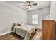 Cozy bedroom featuring hardwood floors, ceiling fan, window, and neutral décor at 2980 Beards Rd, Buford, GA 30518