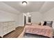 Cozy bedroom featuring wood floors, a neutral color scheme, and classic furniture creating a warm and inviting atmosphere at 2980 Beards Rd, Buford, GA 30518