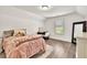Charming bedroom features hardwood floors, a window with shutter blinds, and soft, neutral decor at 2980 Beards Rd, Buford, GA 30518