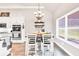 Bright dining area featuring a chandelier, large window with blind, and a bar-height table at 2980 Beards Rd, Buford, GA 30518