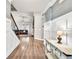 Inviting entryway with wood floors, wainscoting, and an open view to the living area, showcasing a modern interior design at 2980 Beards Rd, Buford, GA 30518