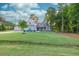Expansive front lawn leads to a lovely home with mature trees, flowering bushes, and a welcoming front porch at 2980 Beards Rd, Buford, GA 30518