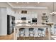 Kitchen featuring white cabinets, granite countertops, stainless appliances, and a center island with seating at 2980 Beards Rd, Buford, GA 30518