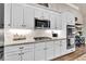 Kitchen features white cabinets, stone countertops, stainless steel appliances, and modern fixtures at 2980 Beards Rd, Buford, GA 30518