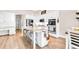 Bright kitchen with white cabinetry, granite countertops, stainless steel appliances, and a center island with bar seating at 2980 Beards Rd, Buford, GA 30518