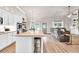 Open concept kitchen and living room with granite counters, stone fireplace and stainless steel appliances at 2980 Beards Rd, Buford, GA 30518