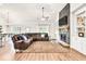 Bright living room with a fireplace, hardwood floors, and open access to the kitchen and dining areas, perfect for entertaining at 2980 Beards Rd, Buford, GA 30518