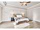Main bedroom features accent wall, tray ceiling, ceiling fan, and hardwood floors at 2980 Beards Rd, Buford, GA 30518