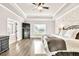 Light-filled main bedroom with tray ceiling and view of ensuite bathroom at 2980 Beards Rd, Buford, GA 30518