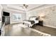Spacious main bedroom features a tray ceiling, accent wall, and hardwood floors at 2980 Beards Rd, Buford, GA 30518