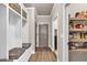 Inviting mudroom features custom built-ins, seating, and convenient access to the pantry and garage at 2980 Beards Rd, Buford, GA 30518