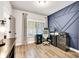 Functional home office with modern accent wall, wood floors, and ample desk space at 2980 Beards Rd, Buford, GA 30518