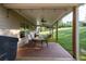 Covered patio with outdoor seating and dining areas, ceiling fans, and views of the well-maintained backyard at 2980 Beards Rd, Buford, GA 30518