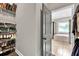 Well-organized walk-in closet featuring shelving with shoes, clothes, and a view into the light and bright ensuite bathroom at 2980 Beards Rd, Buford, GA 30518