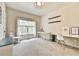 Bright bedroom with neutral walls, carpeted floor, built-in desk, and a large window for natural light at 3060 Mccannon Mill Dr, Dacula, GA 30019