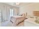 Cozy bedroom bathed in neutral tones features a comfortable bed and side table at 3060 Mccannon Mill Dr, Dacula, GA 30019