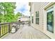 Outdoor deck with grill, chairs, and a view of the surrounding trees and backyard at 3060 Mccannon Mill Dr, Dacula, GA 30019