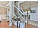 Elegant foyer featuring hardwood floors, a staircase with a black metal railing, and stylish decor at 3060 Mccannon Mill Dr, Dacula, GA 30019