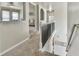 Upstairs hallway showcases staircase and transitions to an upstairs sitting room or living space at 3060 Mccannon Mill Dr, Dacula, GA 30019