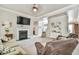 Cozy living room with fireplace, TV, and plush furniture, creating a comfortable gathering space at 3060 Mccannon Mill Dr, Dacula, GA 30019