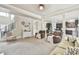 Open living room area with neutral carpet, staircase, and seamlessly connected to the kitchen at 3060 Mccannon Mill Dr, Dacula, GA 30019