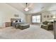 Huge main bedroom with tray ceiling, sitting area, nightstands and a large bed and padded bench at 3060 Mccannon Mill Dr, Dacula, GA 30019