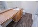 A bright bathroom with wood-look floors, a functional vanity, and a modern design at 2326 Bigwood Trl, Atlanta, GA 30349
