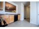 This kitchen features wooden cabinets, tile flooring, and a view into the living room at 2326 Bigwood Trl, Atlanta, GA 30349