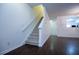 The living room features hardwood floors, white walls, a staircase to the upper level, and is open to the kitchen at 2326 Bigwood Trl, Atlanta, GA 30349