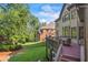 A backyard view from the deck, showcasing the well-maintained lawn and adjacent building at 2517 Stone Manor Dr, Buford, GA 30519