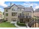 A tiered deck overlooks the yard of this home, also featuring a walk-out patio at 2517 Stone Manor Dr, Buford, GA 30519